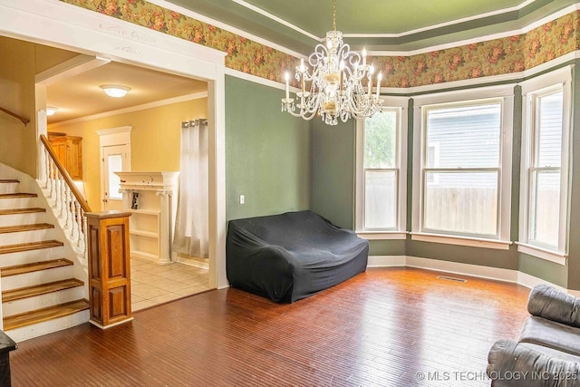 210 S Water St, Sapulpa, OK 74066 - sitting room featuring ornamental molding, healthy amount of natural light, a chandelier, wood finished floors, and stairs