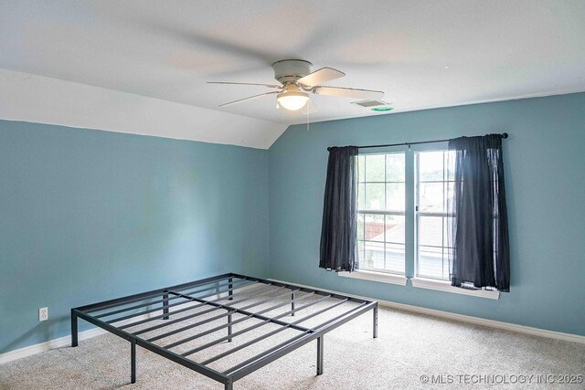 210 S Water St, Sapulpa, OK 74066 - unfurnished bedroom with carpet flooring, baseboards, lofted ceiling, and a ceiling fan