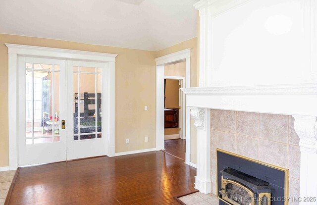 210 S Water St, Sapulpa, OK 74066 - unfurnished living room featuring wood finished floors, french doors, and baseboards
