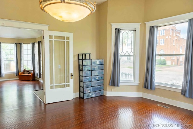 210 S Water St, Sapulpa, OK 74066 - unfurnished room featuring healthy amount of natural light and dark wood-type flooring