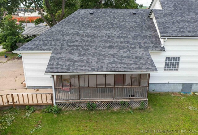 210 S Water St, Sapulpa, OK 74066 - back of property with a shingled roof, a yard, and a sunroom