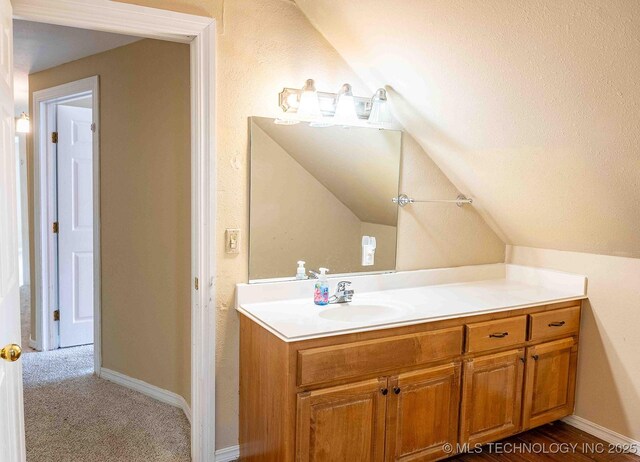 210 S Water St, Sapulpa, OK 74066 - bathroom featuring vanity, lofted ceiling, and baseboards