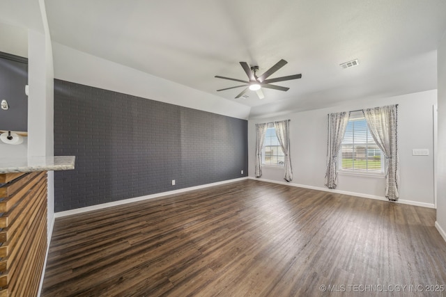 5976 E 147th St S, Bixby, OK 74008 - unfurnished living room featuring baseboards, dark wood-type flooring, ceiling fan, and brick wall