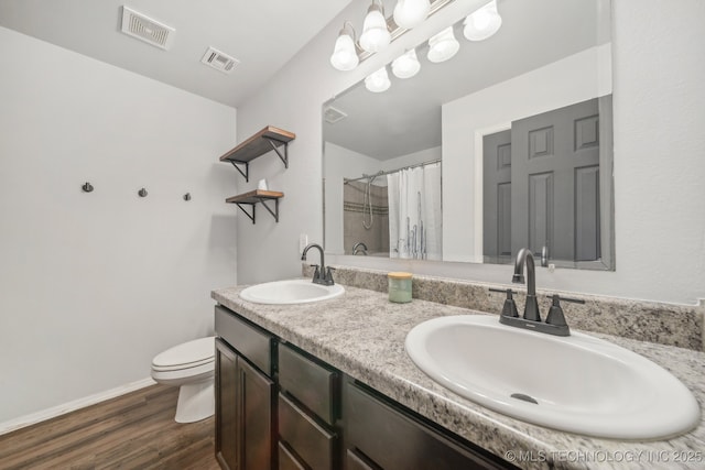 5976 E 147th St S, Bixby, OK 74008 - bathroom with double vanity, toilet, wood finished floors, curtained shower, and baseboards