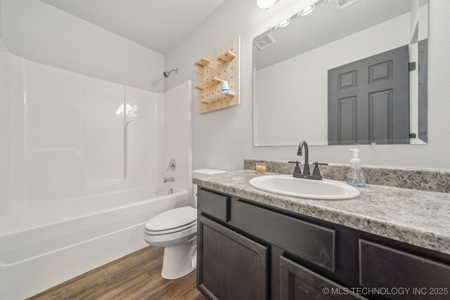 5976 E 147th St S, Bixby, OK 74008 - bathroom with toilet, vanity, wood finished floors, and shower / bathtub combination