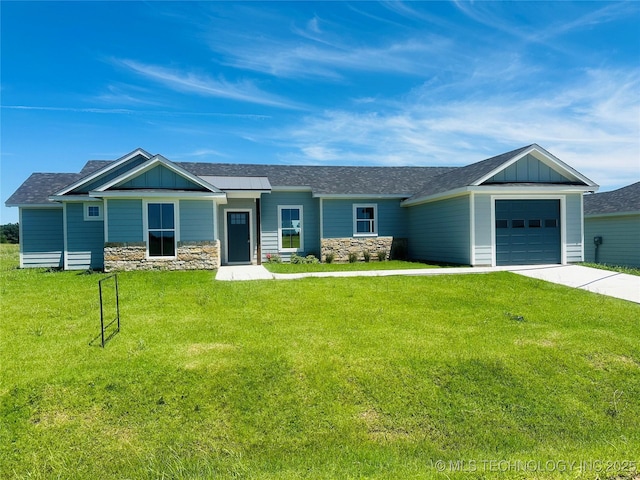 99 Treaty, Calera, OK 74730 - view of front of home featuring board and batten siding, concrete driveway, stone siding, and an attached garage