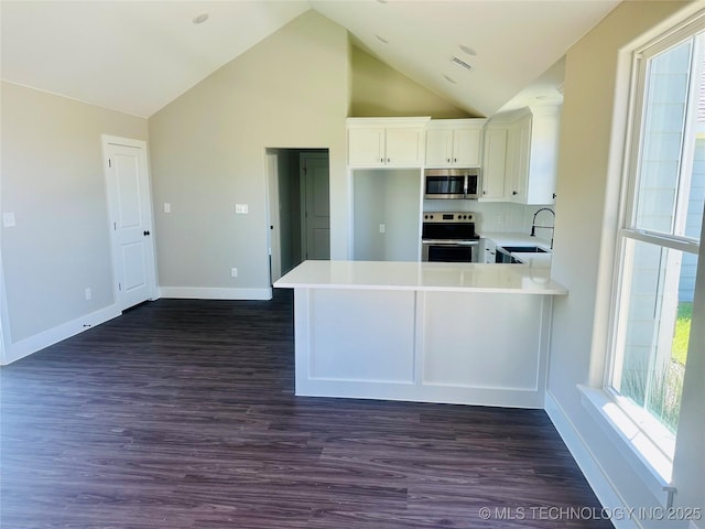 99 Treaty, Calera, OK 74730 - kitchen with appliances with stainless steel finishes, a sink, light countertops, white cabinetry, and healthy amount of natural light