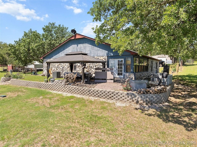 6472 Kings Rd, Ardmore, OK 73401 - back of property with stone siding, a gazebo, a lawn, and cooling unit