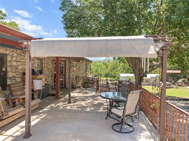 6472 Kings Rd, Ardmore, OK 73401 - view of patio featuring a pergola, an outbuilding, and outdoor dining space