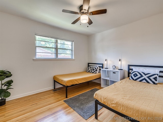 1518 E 58th St, Tulsa, OK 74105 - bedroom with wood finished floors, crown molding, baseboards, and ceiling fan