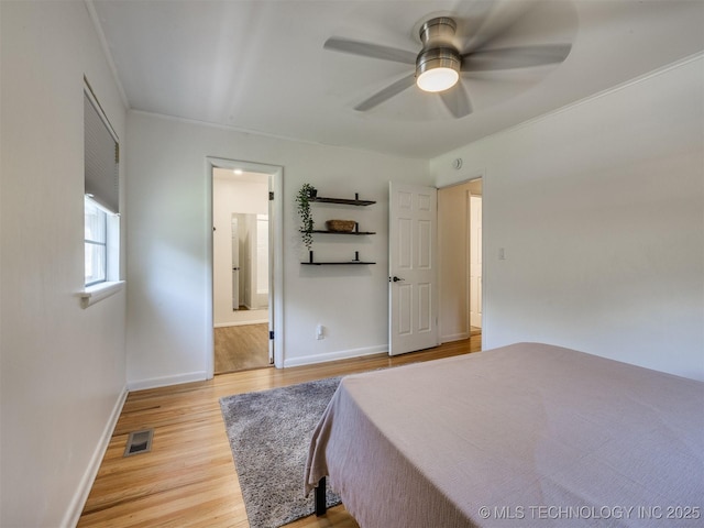 1518 E 58th St, Tulsa, OK 74105 - bedroom featuring light wood finished floors, baseboards, connected bathroom, and a ceiling fan