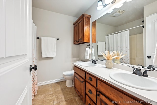 4701 S 179th E Ave, Tulsa, OK 74134 - bathroom with double vanity, baseboards, toilet, tile patterned flooring, and curtained shower