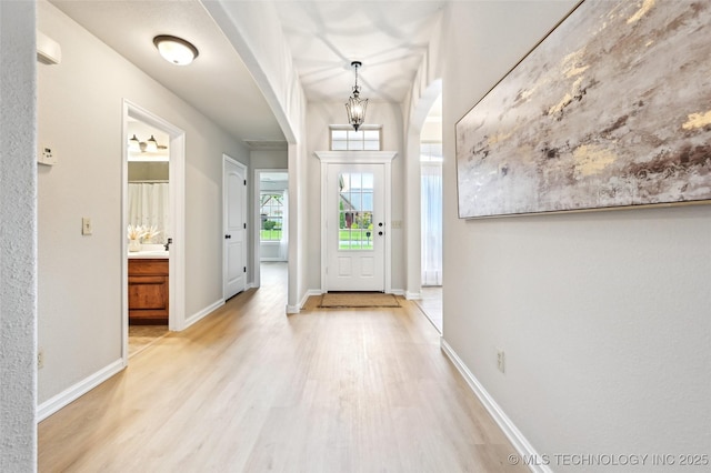 4701 S 179th E Ave, Tulsa, OK 74134 - foyer entrance with arched walkways, light wood finished floors, and baseboards