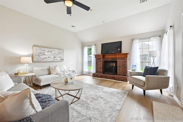 4701 S 179th E Ave, Tulsa, OK 74134 - living room with healthy amount of natural light, wood finished floors, lofted ceiling, a brick fireplace, and a ceiling fan