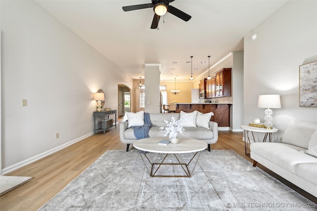 4701 S 179th E Ave, Tulsa, OK 74134 - living room featuring a ceiling fan, light wood finished floors, arched walkways, and baseboards
