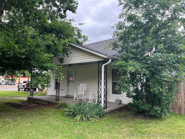 610 W Washington Ave, Krebs, OK 74501 - back of property featuring a porch, a yard, and roof with shingles