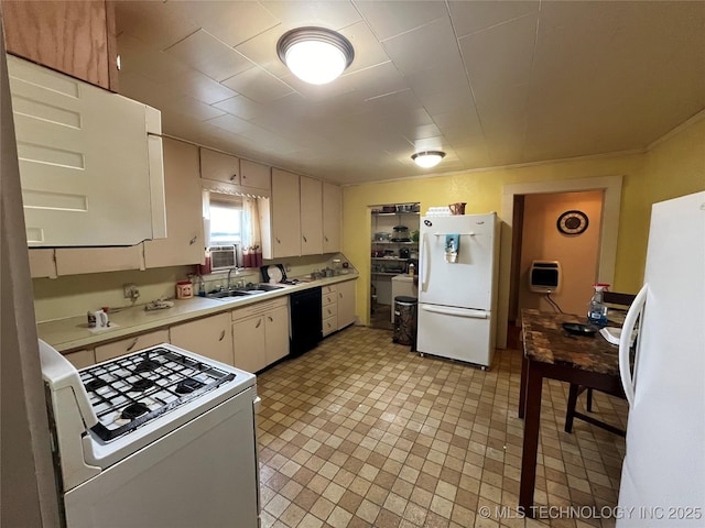 610 W Washington Ave, Krebs, OK 74501 - kitchen with white appliances, light countertops, a sink, heating unit, and white cabinets