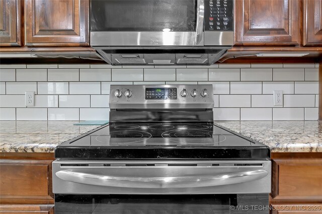 12441 S 209th W Ave, Sapulpa, OK 74066 - kitchen with stainless steel appliances, backsplash, light stone countertops, and brown cabinetry