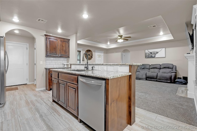 12441 S 209th W Ave, Sapulpa, OK 74066 - kitchen featuring appliances with stainless steel finishes, a tray ceiling, ceiling fan, open floor plan, and a sink