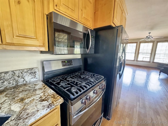 20413 E Allen Rd, Tahlequah, OK 74464 - kitchen featuring stainless steel appliances, light wood-style flooring, a ceiling fan, and light stone countertops