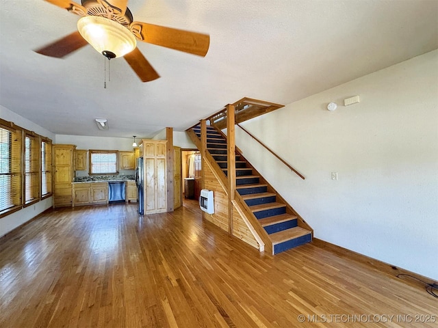 20413 E Allen Rd, Tahlequah, OK 74464 - unfurnished living room with stairs, dark wood finished floors, heating unit, and a ceiling fan