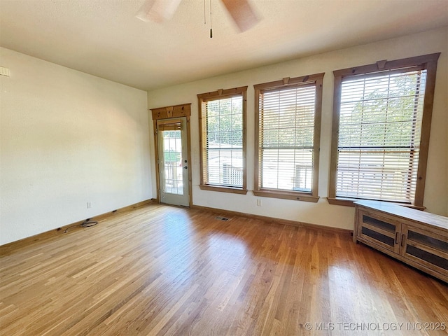 20413 E Allen Rd, Tahlequah, OK 74464 - empty room with light wood-style floors, healthy amount of natural light, and ceiling fan