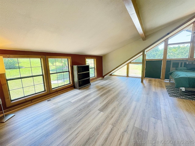 20413 E Allen Rd, Tahlequah, OK 74464 - unfurnished living room featuring a textured ceiling and wood finished floors
