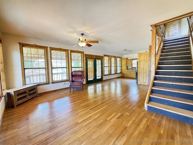 20413 E Allen Rd, Tahlequah, OK 74464 - unfurnished living room featuring light wood-style floors, stairway, and ceiling fan