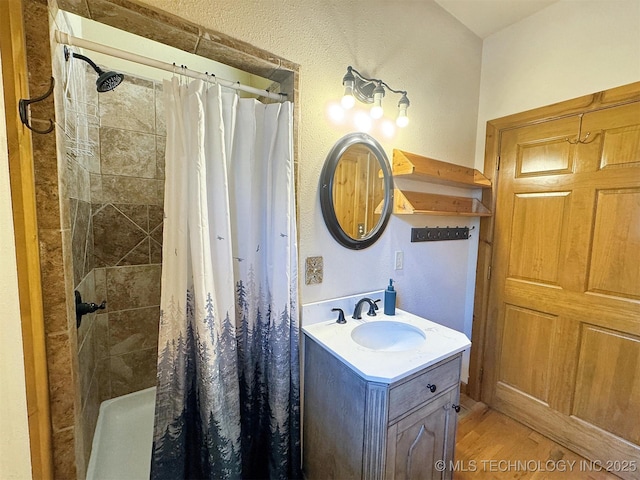 20413 E Allen Rd, Tahlequah, OK 74464 - full bathroom featuring tiled shower, vanity, and wood finished floors