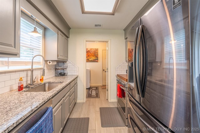 20903 E 35th St S, Broken Arrow, OK 74014 - kitchen with appliances with stainless steel finishes, a sink, backsplash, and gray cabinets