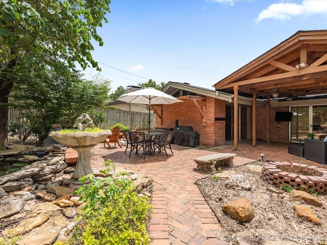2310 Skyline Dr, Bartlesville, OK 74006 - view of patio featuring ceiling fan, a grill, an outdoor fire pit, and outdoor dining area