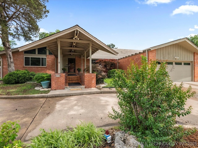 2310 Skyline Dr, Bartlesville, OK 74006 - mid-century home with brick siding, a garage, and driveway