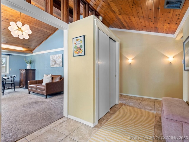 2310 Skyline Dr, Bartlesville, OK 74006 - hallway featuring wood ceiling, baseboards, tile patterned flooring, carpet flooring, and a chandelier