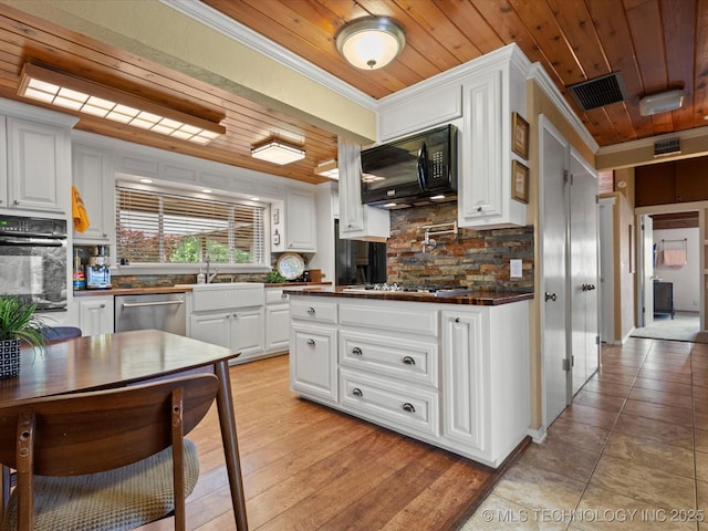 2310 Skyline Dr, Bartlesville, OK 74006 - kitchen featuring black appliances, wood ceiling, dark countertops, decorative backsplash, and crown molding