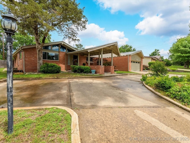 2310 Skyline Dr, Bartlesville, OK 74006 - mid-century inspired home featuring brick siding and driveway