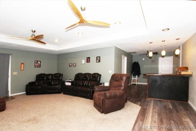 410 Shawnee St, So Coffeyville, OK 74072 - living room with a ceiling fan, baseboards, wood finished floors, recessed lighting, and a tray ceiling