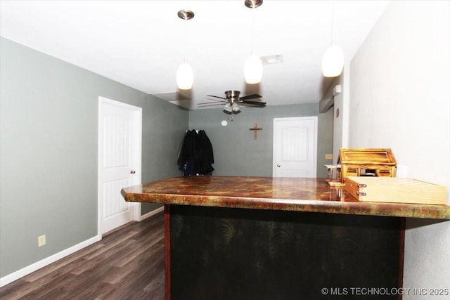 410 Shawnee St, So Coffeyville, OK 74072 - kitchen featuring dark wood-style flooring, baseboards, hanging light fixtures, and a ceiling fan