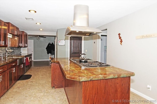 410 Shawnee St, So Coffeyville, OK 74072 - kitchen with island exhaust hood, a sink, stainless steel gas stovetop, a ceiling fan, and a center island