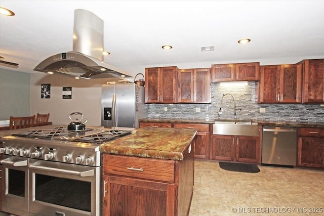 410 Shawnee St, So Coffeyville, OK 74072 - kitchen featuring appliances with stainless steel finishes, island exhaust hood, a sink, backsplash, and recessed lighting