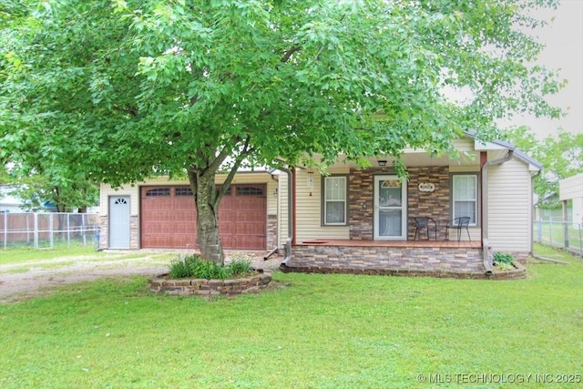 410 Shawnee St, So Coffeyville, OK 74072 - view of front of house with driveway, an attached garage, a porch, and stone siding