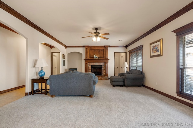 6601 E 85th St, Owasso, OK 74055 - living room with baseboards, plenty of natural light, a brick fireplace, a ceiling fan, and crown molding