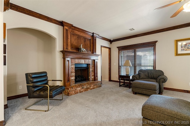 6601 E 85th St, Owasso, OK 74055 - living area featuring carpet floors, ornamental molding, a brick fireplace, ceiling fan, and baseboards
