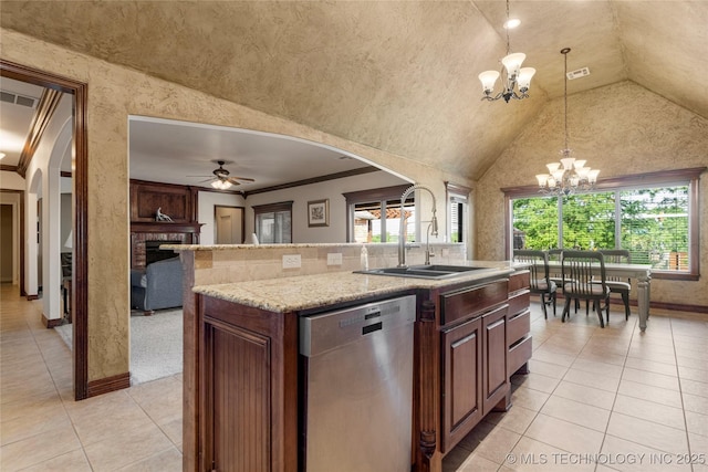 6601 E 85th St, Owasso, OK 74055 - kitchen featuring stainless steel dishwasher, arched walkways, a chandelier, a sink, and light tile patterned flooring