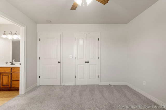 6601 E 85th St, Owasso, OK 74055 - unfurnished bedroom with light carpet, baseboards, ceiling fan, and a closet