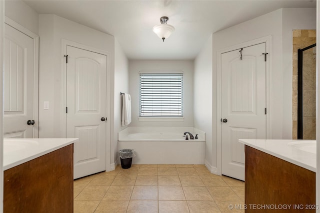 6601 E 85th St, Owasso, OK 74055 - full bathroom featuring vanity, a bath, a stall shower, and tile patterned floors