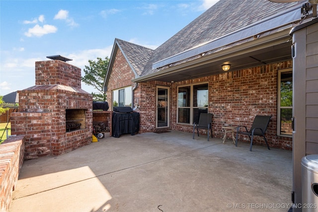 6601 E 85th St, Owasso, OK 74055 - view of patio / terrace featuring an outdoor brick fireplace