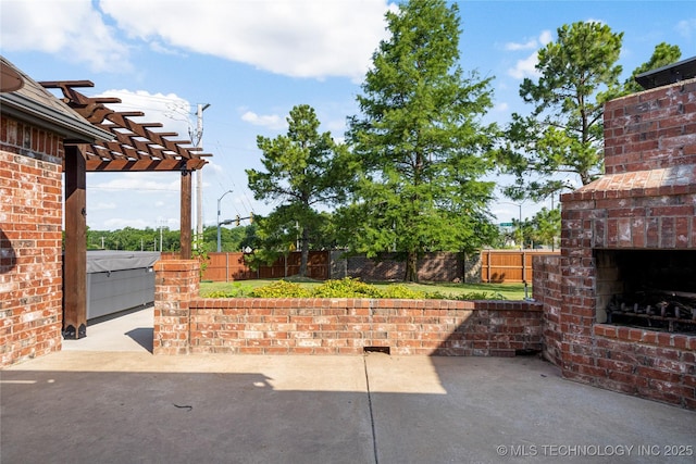 6601 E 85th St, Owasso, OK 74055 - fenced backyard featuring an outdoor brick fireplace, a patio area, and a pergola