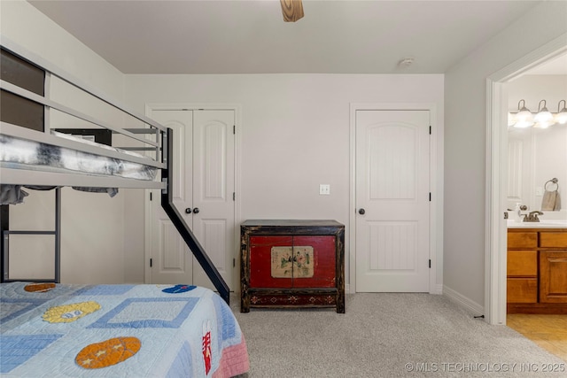 6601 E 85th St, Owasso, OK 74055 - bedroom with light colored carpet, ensuite bathroom, and baseboards