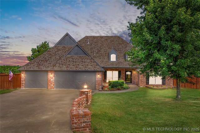 6601 E 85th St, Owasso, OK 74055 - view of front of property with asphalt driveway, an attached garage, brick siding, and a shingled roof