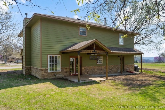 9012 S 49th W Ave, Tulsa, OK 74131 - rear view of house featuring a chimney, a patio, and a yard